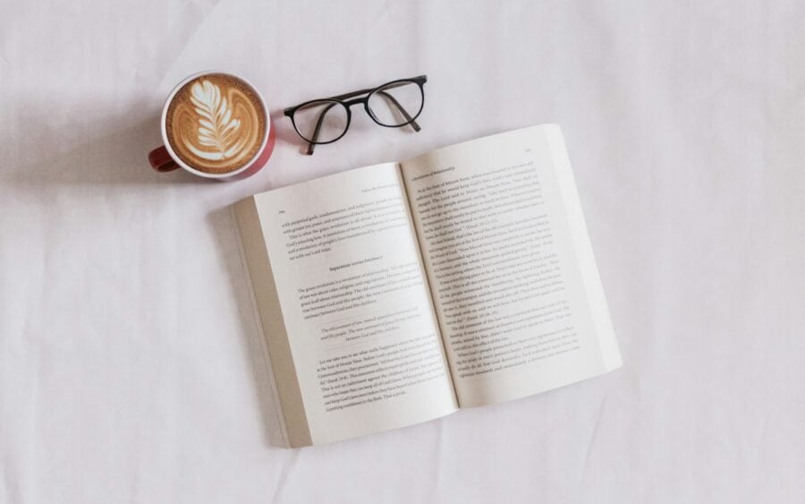 Minimalist electronic ink tablet and coffee cup on table