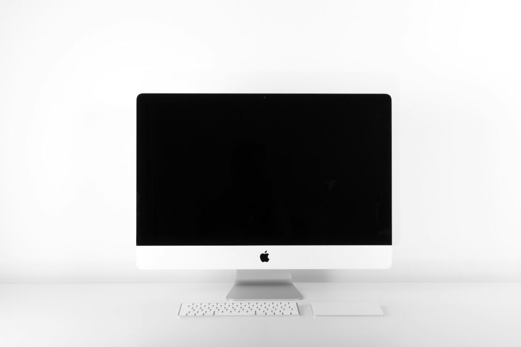 Sleek modern minimalist wooden desk setup with monitor and lamp