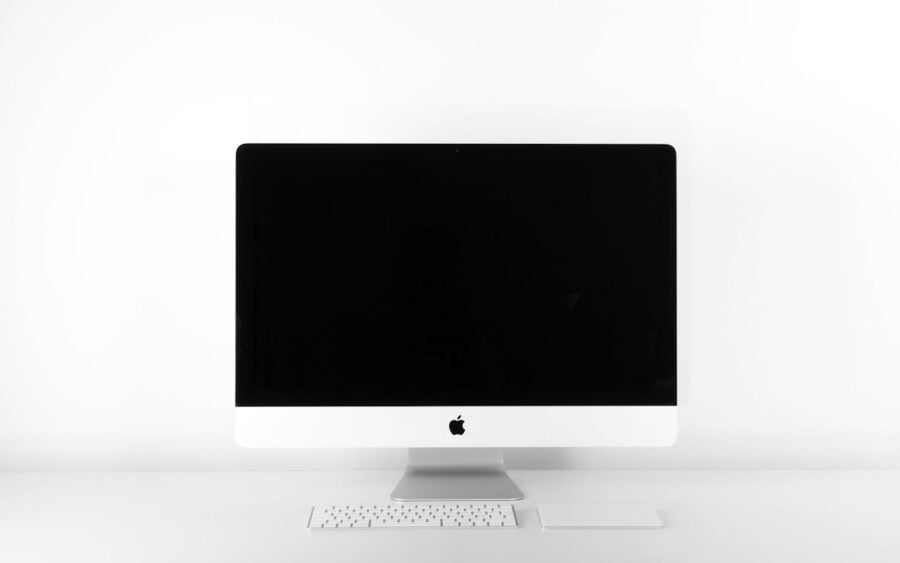 Sleek modern minimalist wooden desk setup with monitor and lamp