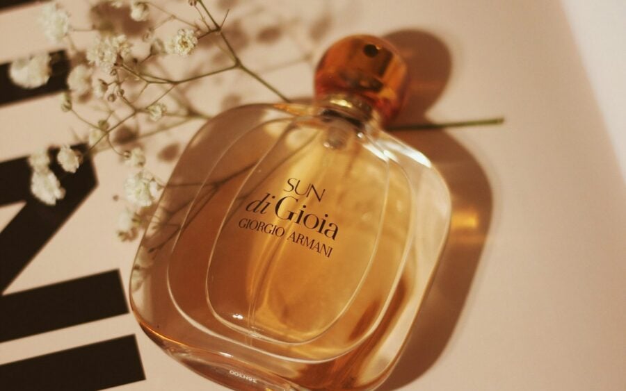 Artisanal perfume glass bottle with natural botanical amber hue