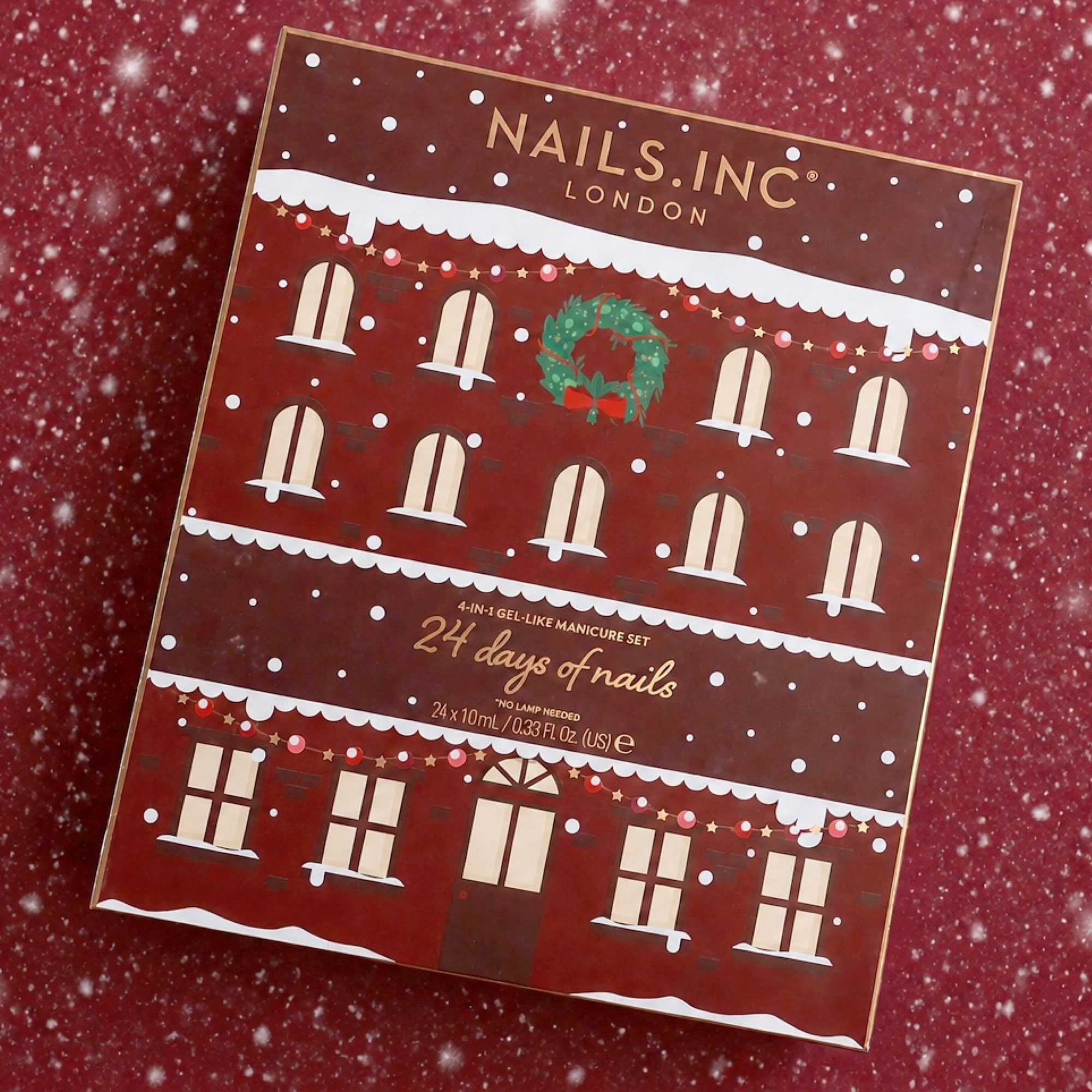 Nails Inc 24 days of nails advent calendar box with snowy rooftop design on red background